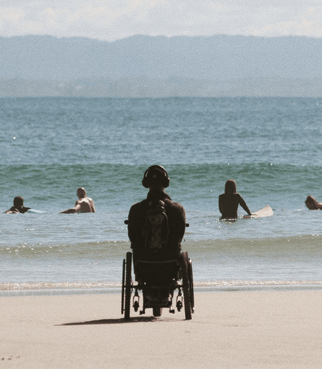 Person in wheelchair enjoying beach view