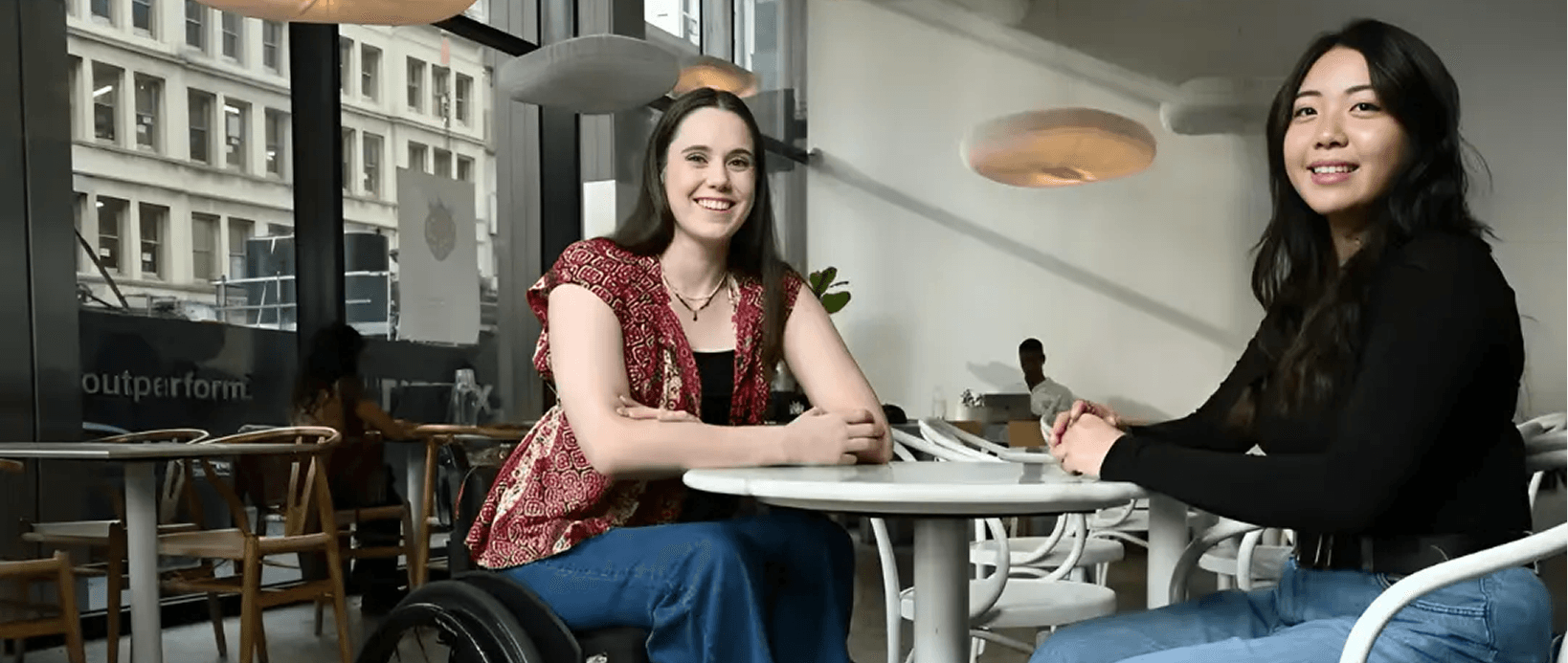 Two people seated at a table in a cafe