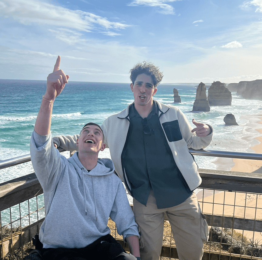 Two people outdoors near the coast